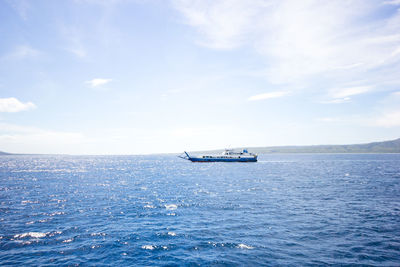 Boat sailing in sea against sky