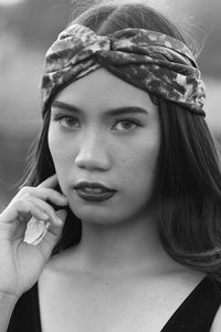 Close-up portrait of beautiful young woman wearing bandana