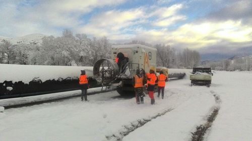 People on road against sky during winter