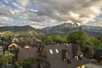 High angle view of townscape by mountains against sky