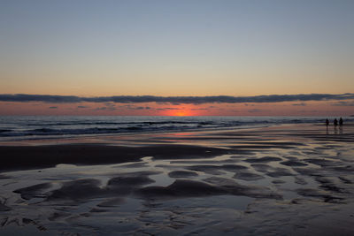 People walking in a sunset landscape