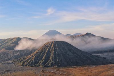 Scenic view of mountains against cloudy sky