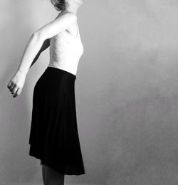 Rear view of woman standing against white background