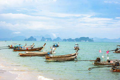 Boats moored on sea against sky