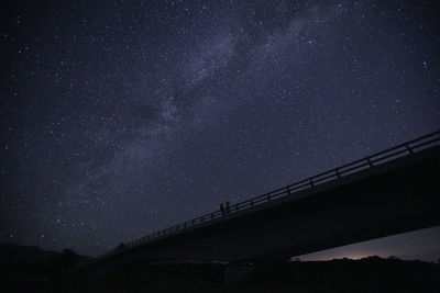 Low angle view of bridge against sky at night