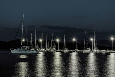 Sailboats in marina at night