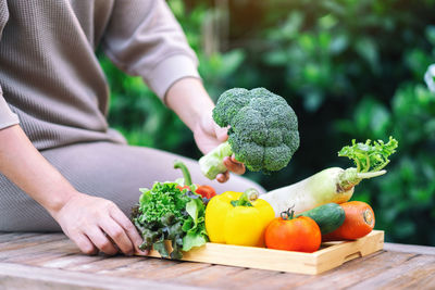 Midsection of person holding fruits