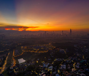 High angle view of city at sunset