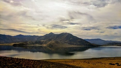 Scenic view of lake and mountains against sky