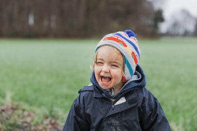 Cute girl with mouth open standing on land