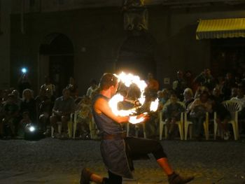 People at illuminated music concert at night