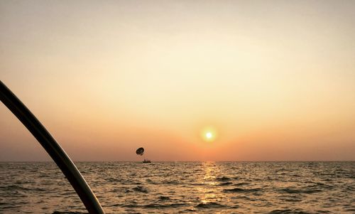 Scenic view of sea against orange sky