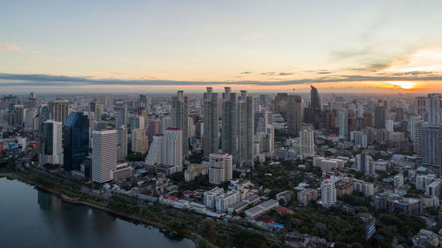 High angle view of city buildings against sky during sunset