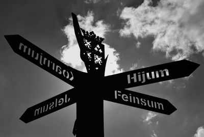 Low angle view of road sign against sky