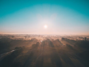 Aerial view of landscape against sky during sunset