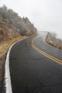 Road passing through mountains against sky