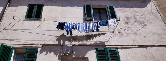 Low angle view of clothes drying outside building