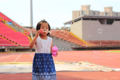 Portrait of girl blowing bubbles