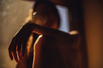 Midsection of woman sitting at home