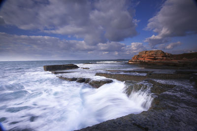 Scenic view of sea against cloudy sky
