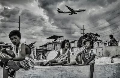 People sitting against sky