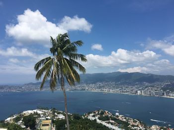 Scenic view of sea by city against sky