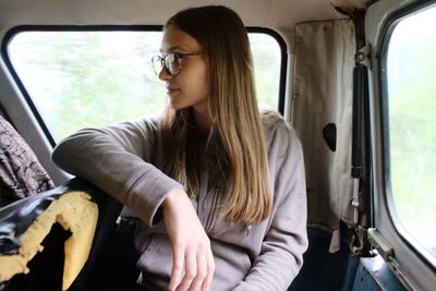 Young woman sitting in car