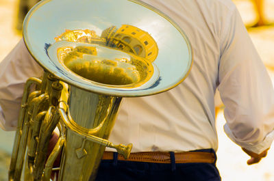 Midsection of man holding trumpet