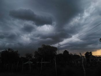 Scenic view of dramatic sky over silhouette trees