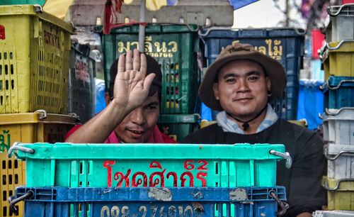 Portrait of smiling man with woman standing in city