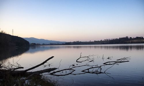 Scenic view of lake against clear sky during sunset