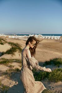 Young woman sitting on beach