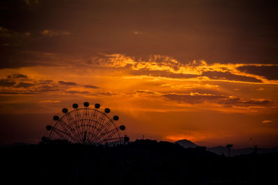 Silhouette ferris wheel against sky during sunset