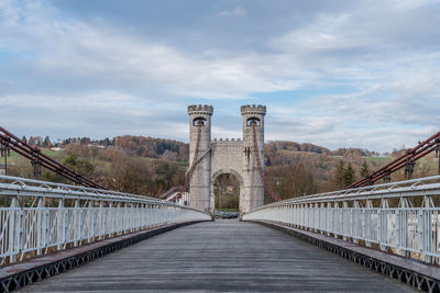 Bridge against cloudy sky