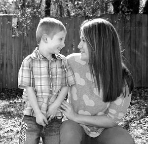 Mother and son sitting at park