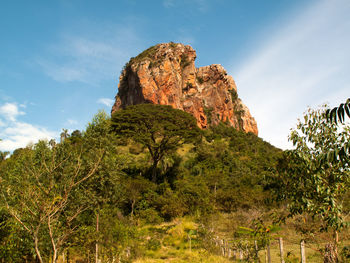 Low angle view of rock formation on mountain against sky