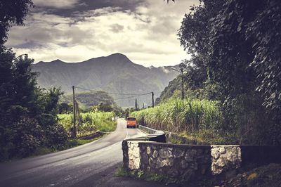 Scenic view of mountains against cloudy sky