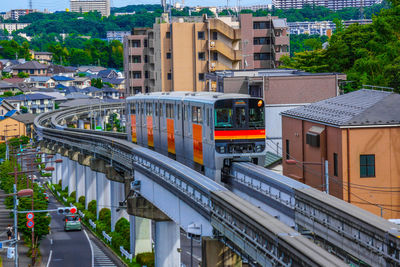 High angle view of train amidst buildings in city