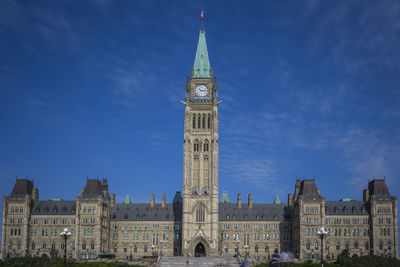 Low angle view of clock tower against sky