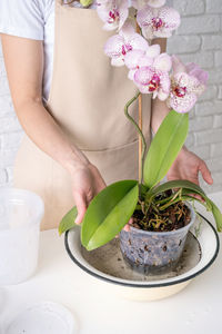 Midsection of woman holding bouquet