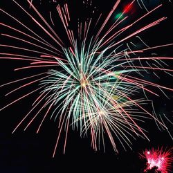 Low angle view of firework display against sky at night