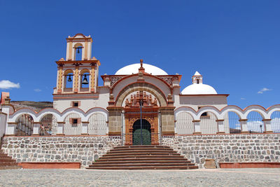 Facade of historic building against blue sky