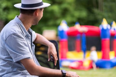 Side view of man wearing hat