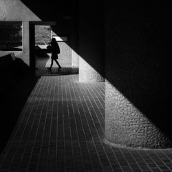 Woman walking on staircase of building