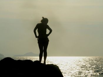 Silhouette woman standing against sky