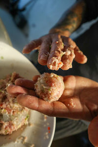 Close-up of hand holding meat