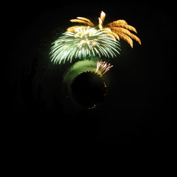 Low angle view of firework display at night