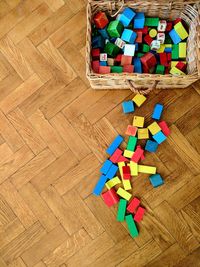 High angle view of multi colored pencils on hardwood floor