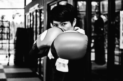 Portrait of woman wearing boxing gloves