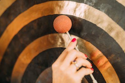 Playing gong in sound bath therapy